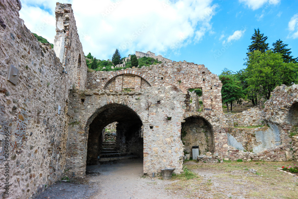Ruins of old medieval monastery in Mystras, Greece against blue sky