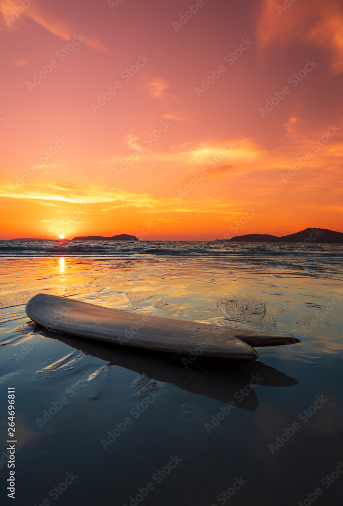 surfboard on the beach in sea shore at sunset time