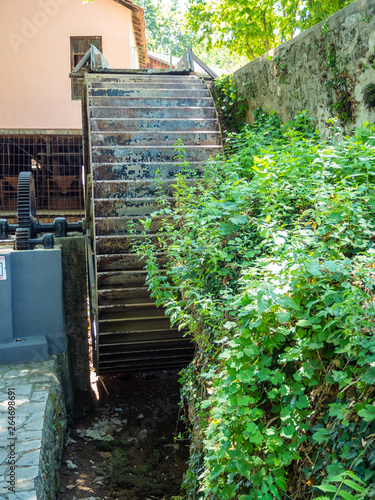 Metal wheel of a water mill in a water museum in the city of Edessa, Greece