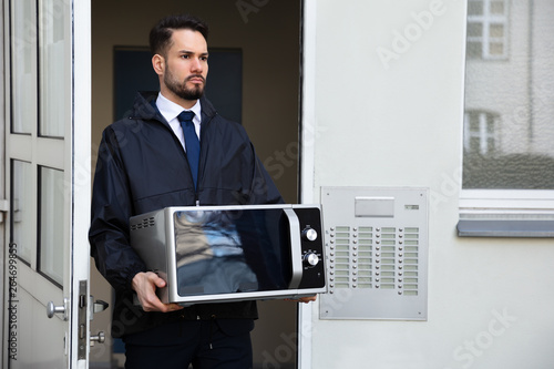 Technician Holding Microwave photo