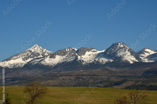 snow-covered mountain peaks with grass landscape in the spring High Tatras Slovakia