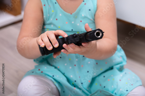 Girl's Hand Holding Gun