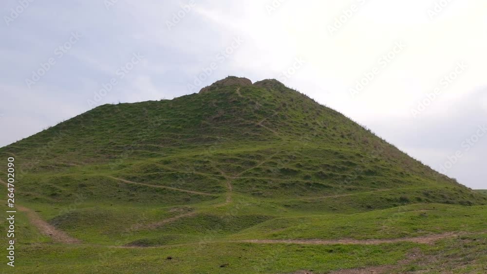 Spring in the counrtyside. Climbing up the green hill in cloudy weather. First person view Spring in the counrtyside. Climbing up the green hill in cloudy weather. First person view