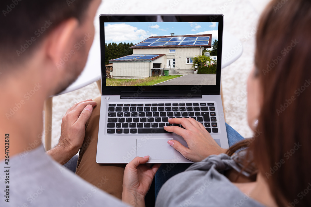 Couple Looking At House On Laptop Couple Looking At House On Laptop