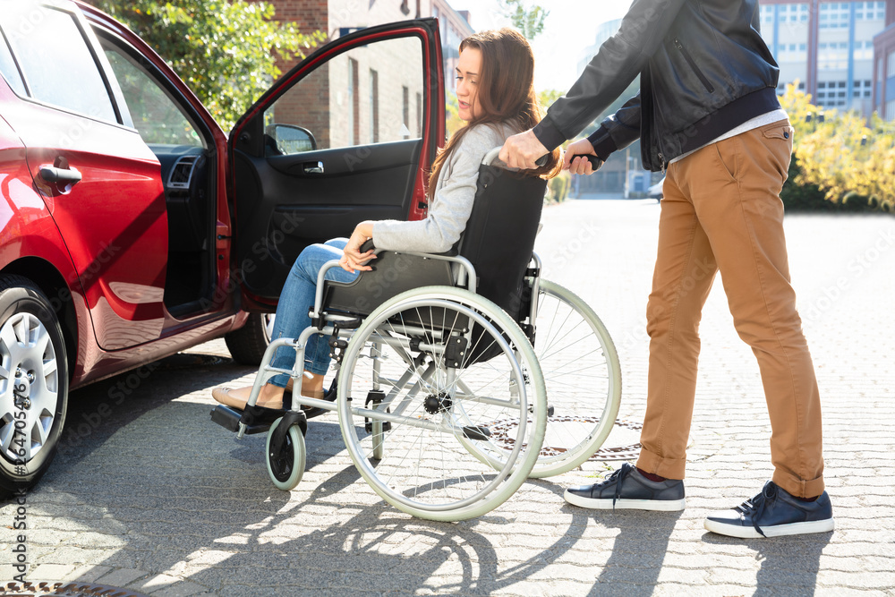 Man With Her Disabled Wife Moving Towards Car Man With Her Disabled Wife Moving Towards Car