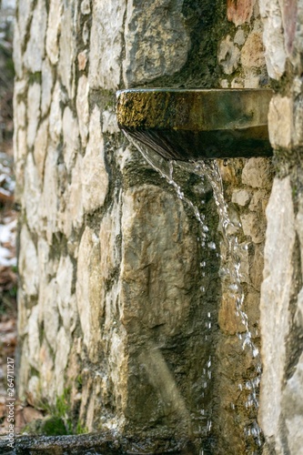Photography Old stone-made fount with water leaking.Drought concept.