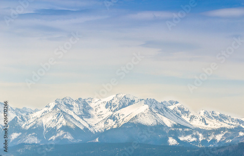 Snowy mountaing peaks of Tatra wrapped in a slight fogg