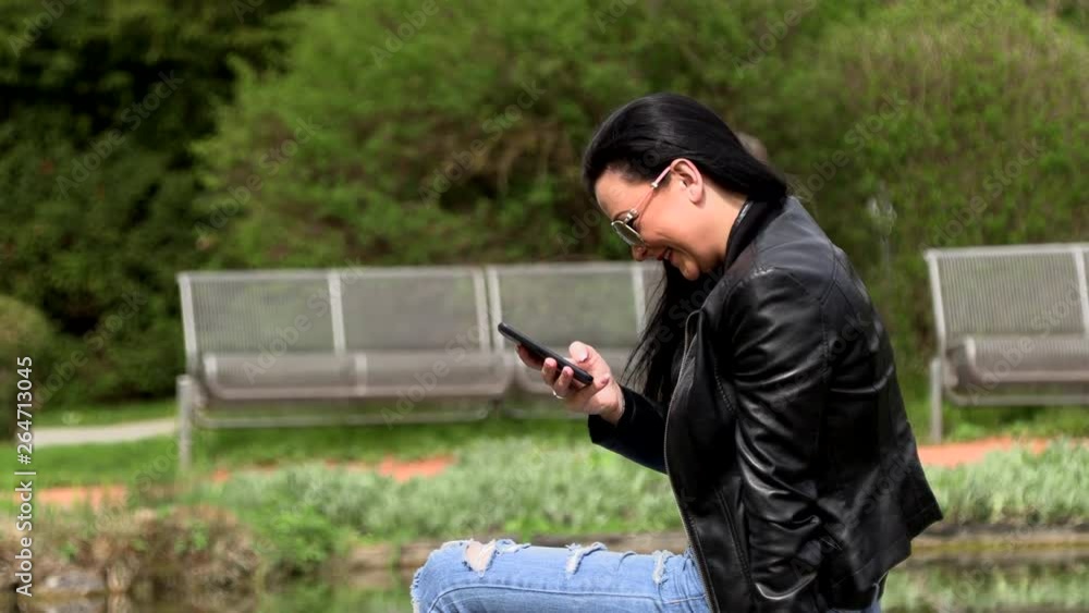 Brunette near the lake with a phone Brunette near the lake with a phone