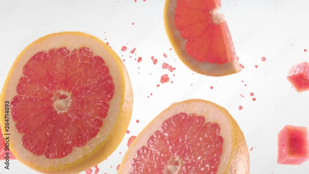 Grapefruit with Slices Falling on White Background Grapefruit with Slices Falling on White Background