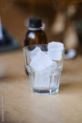 glass of coffee cold brew and ice on wooden table