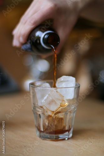 glass of coffee cold brew and ice on wooden table