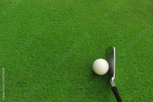 Golf balls and golf clubs on green grass.Golf equipment in the top view.Sports that people around the world play during the holidays for health.
