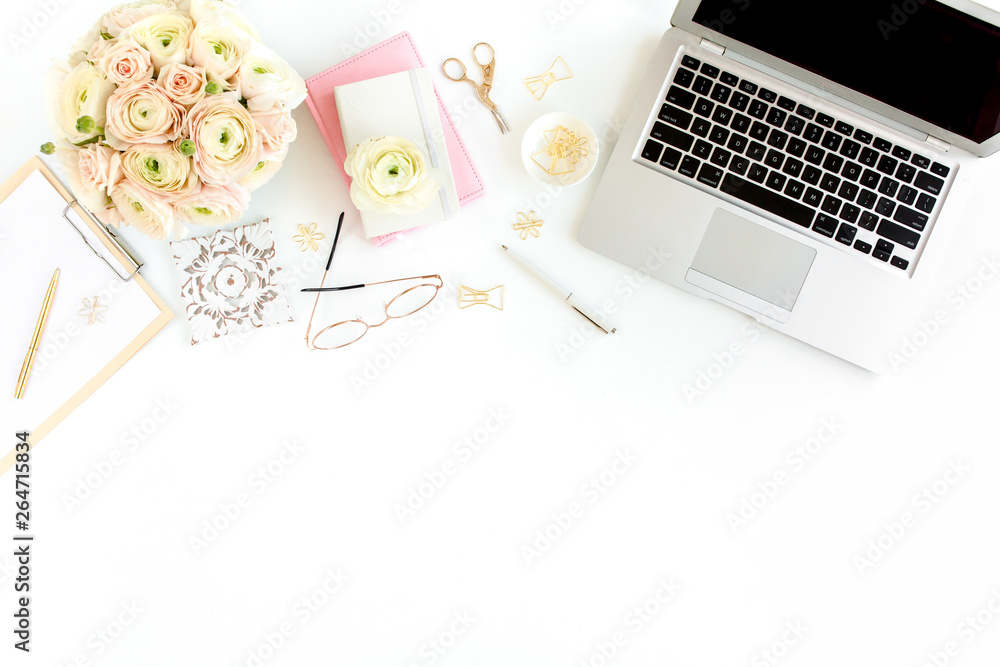 Stylized women's home office desk. Workspace with laptop, computer, bouquet ranunculus and roses, clipboard, feminine golden fashion accessories isolated on white background. Flat lay. Top view. Stylized women's home office desk. Workspace with laptop, computer, bouquet ranunculus and roses, clipboard, feminine golden fashion accessories isolated on white background. Flat lay. Top view.