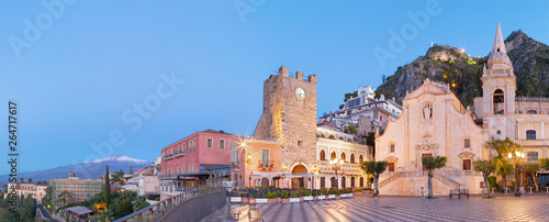 Taormina - The square Piazza IX Aprile and St. Joseph church, Porta di Mezzo gate and Mt. Etna volcano in the background.