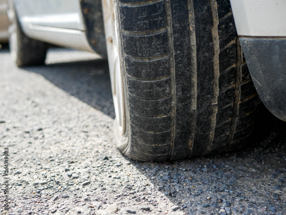 Flat tire on parking car, shallow depth of field, copy space. Flat tire on parking car, shallow depth of field, copy space.
