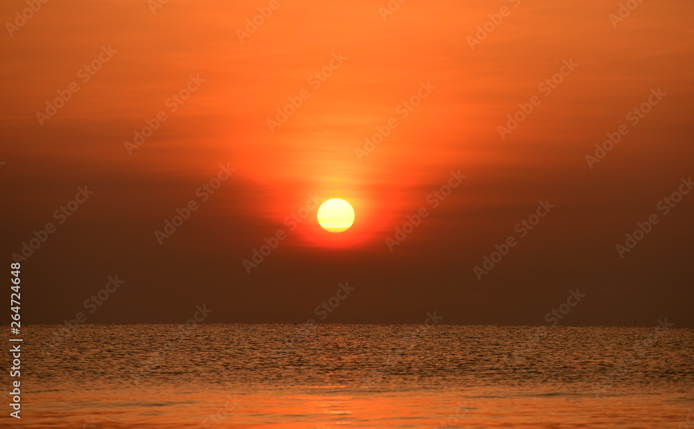 The rising sun view and the beach. Beautiful golden yellow sky and sun The view of the beach,
