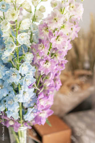 Bunch of fresh delphinium on table. Bouquet of delphinium. gradient flowers from blue to purple