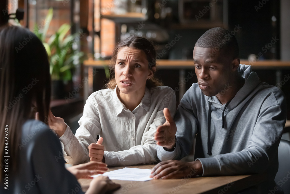 Diverse family couple clients having claim about contract conditions