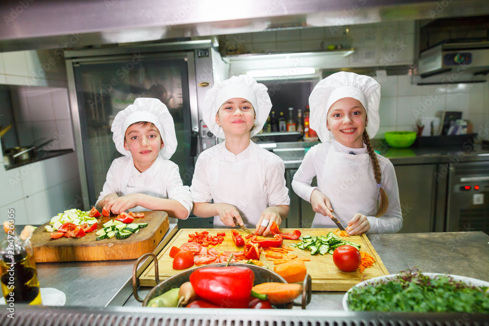 children cooking lunch in a restaurant kitchen.