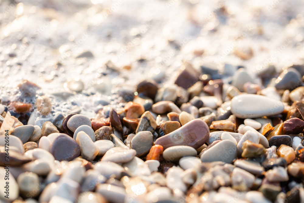 Close up beach stones on the seashore. Summer sunrise on coast, Corfu island, Greece. Beach Ionian sea. Wallpaper Close up beach stones on the seashore. Summer sunrise on coast, Corfu island, Greece. Beach Ionian sea. Wallpaper
