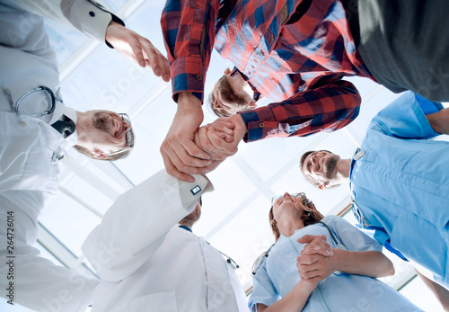 Doctors greet a colleague in a team with a handshake