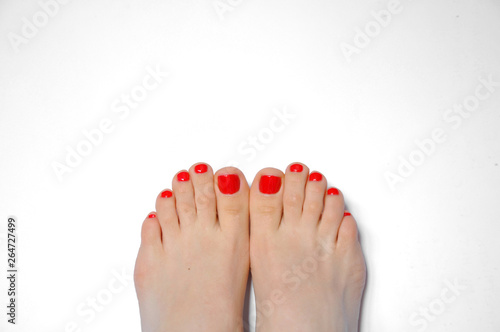 Woman's legs with red pedicure. On a white background