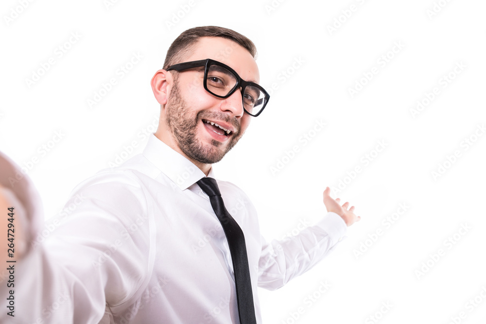 Handsome bearded young business man taking selfie smiling isolated over white background. Handsome bearded young business man taking selfie smiling isolated over white background.
