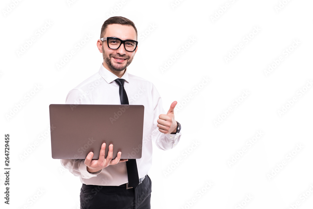 Picture of handsome young bearded man holding laptop showing thumbs up standing over white wall background isolated. Picture of handsome young bearded man holding laptop showing thumbs up standing over white wall background isolated.