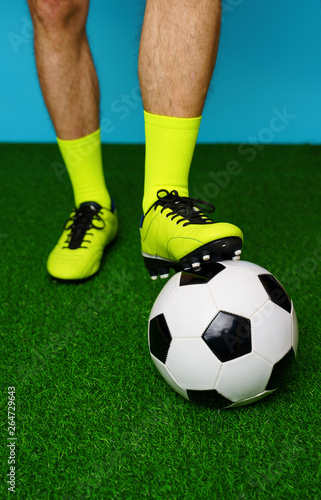 Fototapeta Naklejka Na Ścianę i Meble -  Soccer player with ball on the green grass.