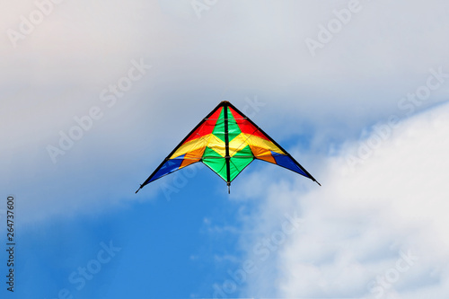 Kite flying on a over blue sky