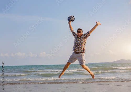 happy man freedom jump ocean sea scape background © Yanukit