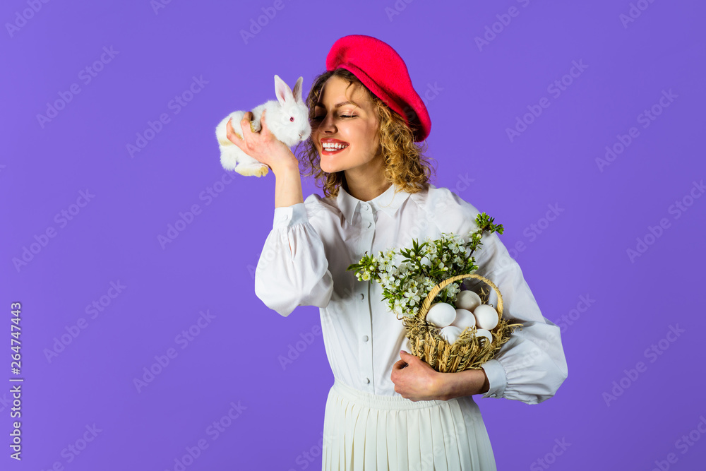 Excited woman in red beret holds Easter bunny rabbit. Easter woman in beret.  Hat. Accessory for
