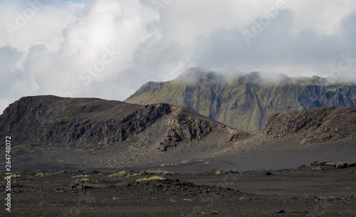 Dramatic iceland landscape with black lava hills looks like a moon.