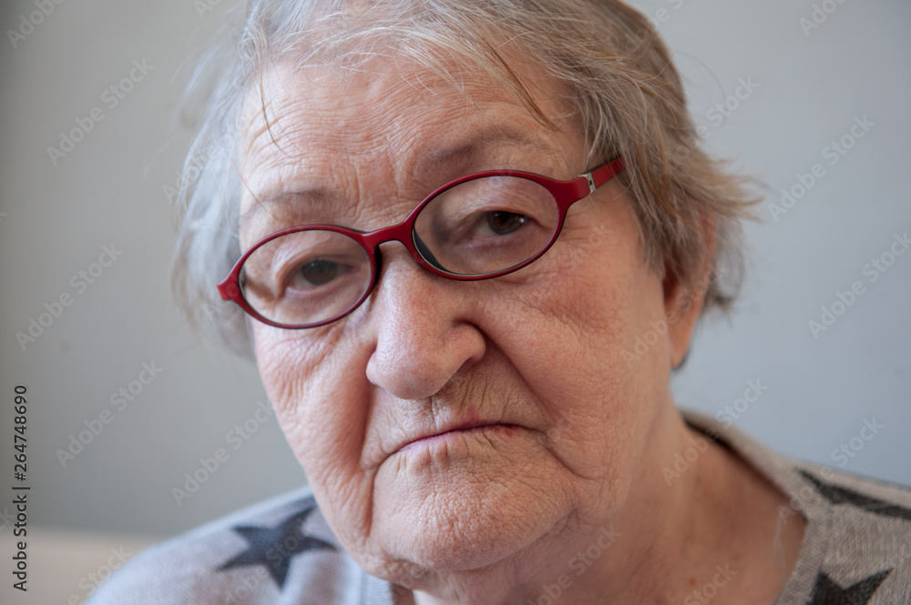 Elderly woman with beautiful face in wrinkles with gray hair with glasses. Closeup portrait. Grandmother Retired waiting for social assistance. Elderly woman with beautiful face in wrinkles with gray hair with glasses. Closeup portrait. Grandmother Retired waiting for social assistance.
