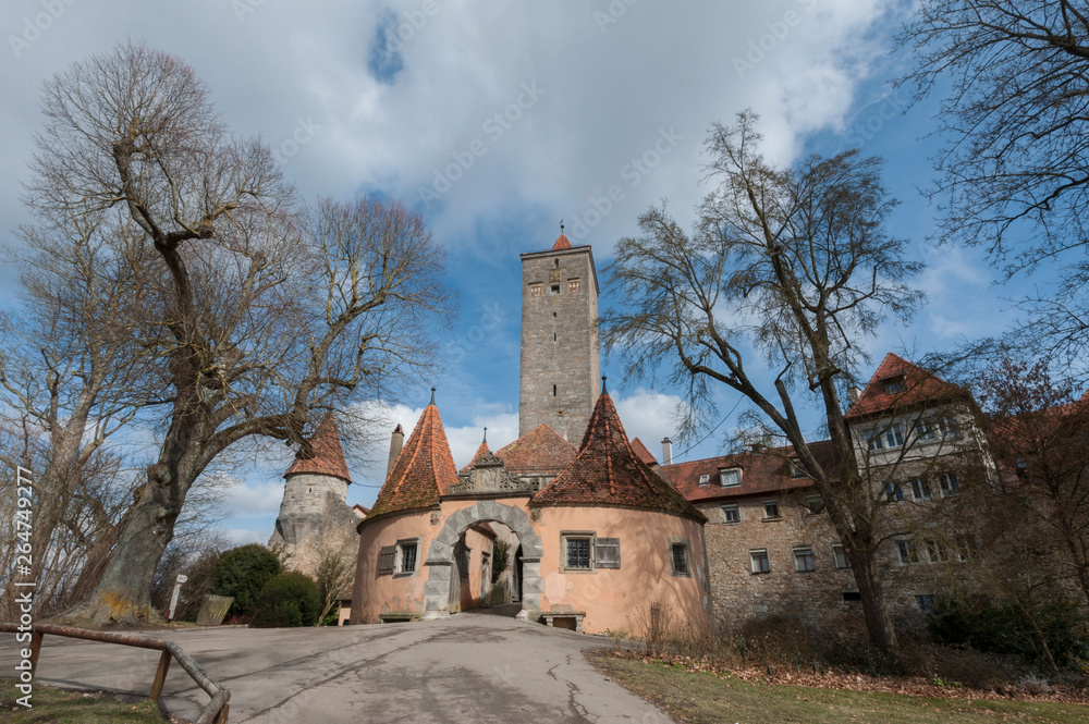 Fototapeta premium Castle tower and city gate at the entrance to the old town of Rothenburg ob der Tauber, one of the most beautiful and romantic villages in Europe, Germany