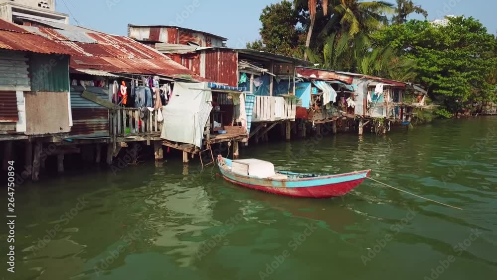 Close-up details poor houses balconies slums in green sea water Asia hopeless ghetto rusty. Ship authentic boat real life dirt. Tropical exotic cityscape Vietnam Asia. Authentic culture style. Drone Close-up details poor houses balconies slums in green sea water Asia hopeless ghetto rusty. Ship authentic boat real life dirt. Tropical exotic cityscape Vietnam Asia. Authentic culture style. Drone