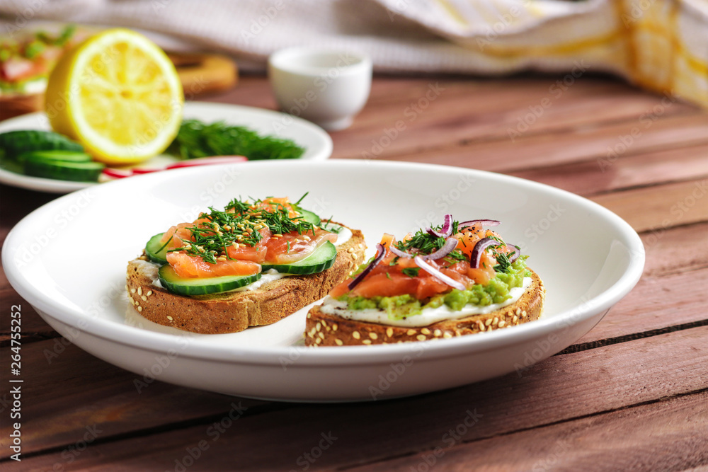 open sandwiches with salmon cucumber mashed avocado red onion dill on white plate close up soft focus open sandwiches with salmon cucumber mashed avocado red onion dill on white plate close up soft focus