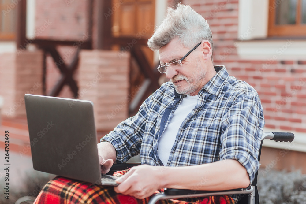 Old sitting in wheelchair using laptop and speaking with his children! Near nursing home! Old sitting in wheelchair using laptop and speaking with his children! Near nursing home!