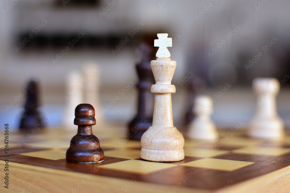 Chess board game with focus on white queen pieces on blurry background Chess board game with focus on white queen pieces on blurry background