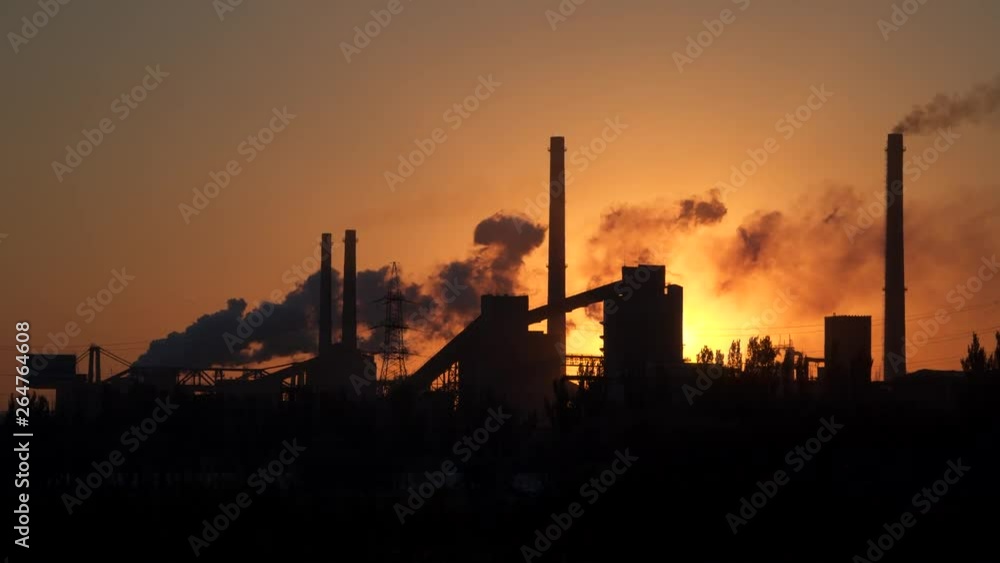 Environmental pollution. Smoke from the pipes on the background of the dawn Environmental pollution. Smoke from the pipes on the background of the dawn