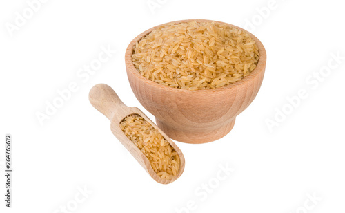 brown rice in wooden bowl and scoop isolated on white background. nutrition. bio. natural food ingredient.