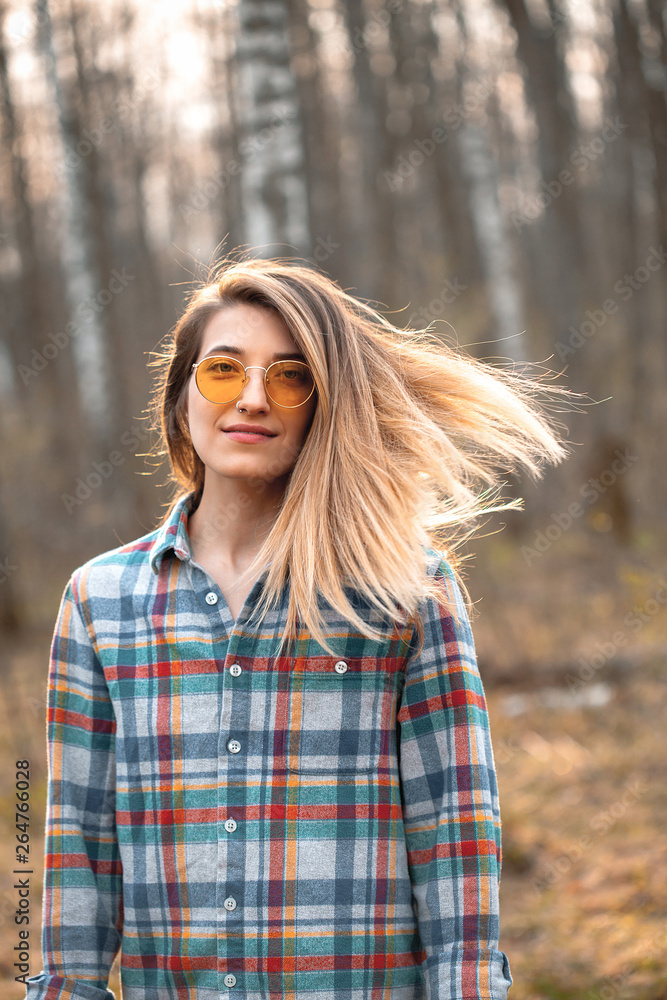 Young woman walking in the forest at sunset. Young woman walking in the forest at sunset.
