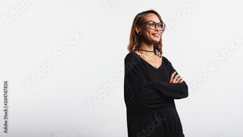 Smiling woman standing with arms crossed