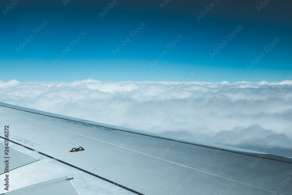 Airplane wing through the aircraft window. Greenhouse effect, global warming. Airplane wing through the aircraft window. Greenhouse effect, global warming.