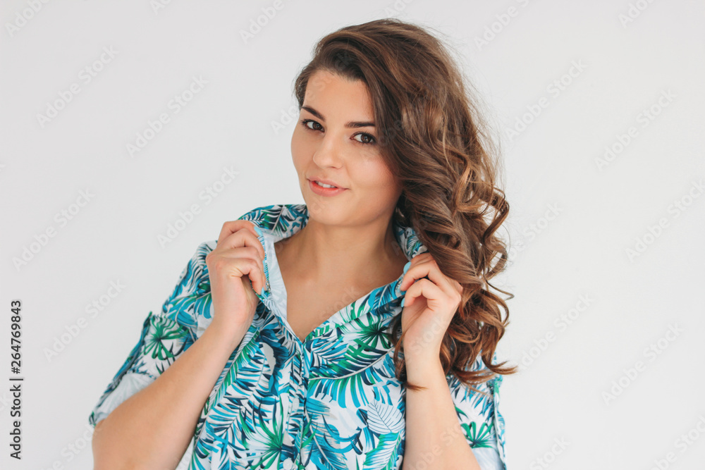 Young charming smiling brunette girl with wavy hair in summer dress, isolate on white background Young charming smiling brunette girl with wavy hair in summer dress, isolate on white background