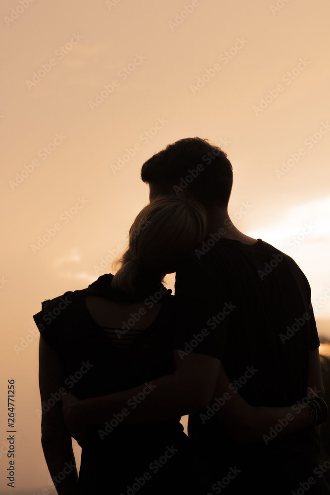 Silhouette close up of sweet couple in love happy time in beautiful sunset