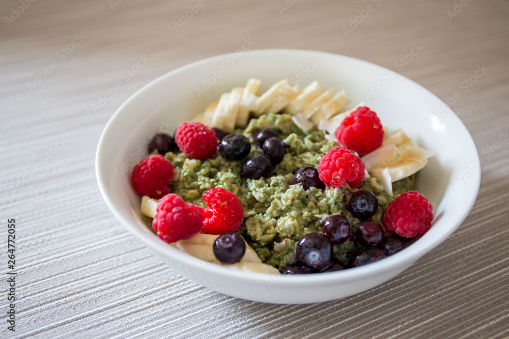 Matcha Oatmeal porridge with ripe berries and banana Matcha Oatmeal porridge with ripe berries and banana