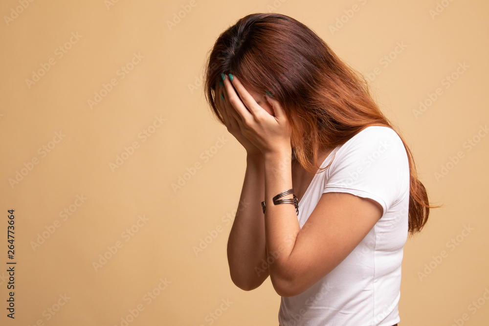 Sad young Asian woman cry with palm to face. Sad young Asian woman cry with palm to face.