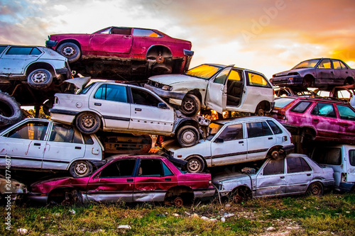 Pile of discarded old cars on junkyard photo