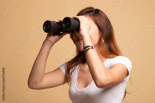 Young Asian woman with binoculars.